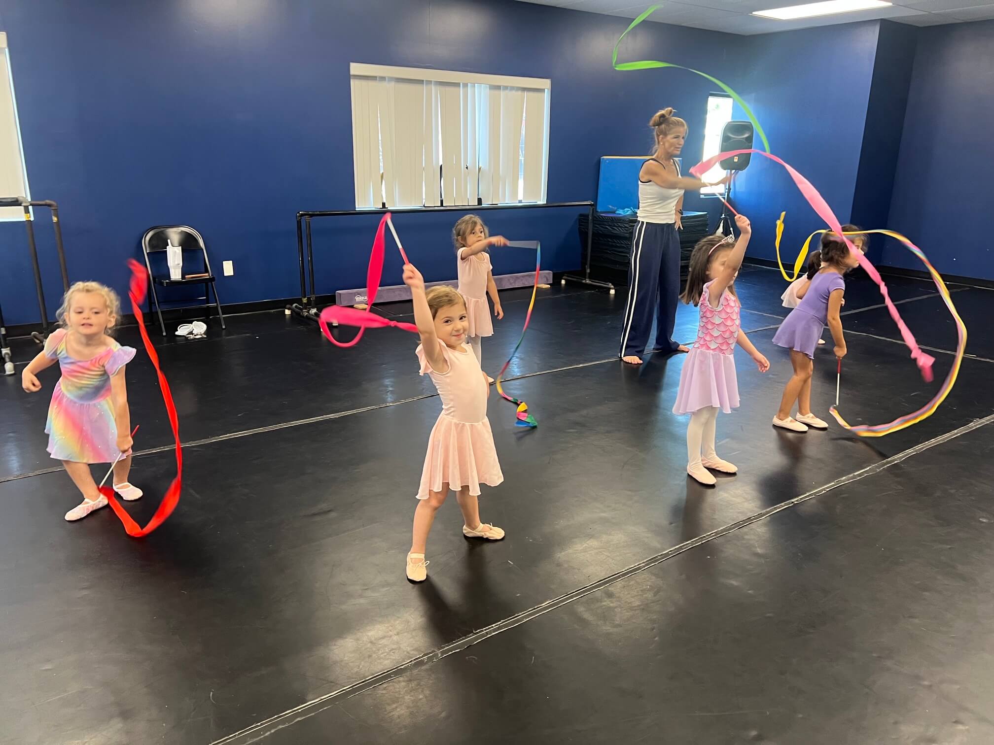 Young dancers waving ribbons during a Toes & Taps class at Kinetic Dance Force in Middletown, CT