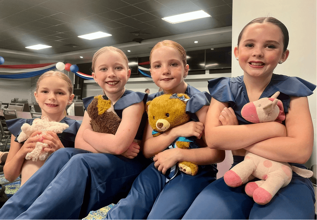 Kinetic Dance Force Competition Troupe dancers in costume with their stuffed animals backstage at a competition